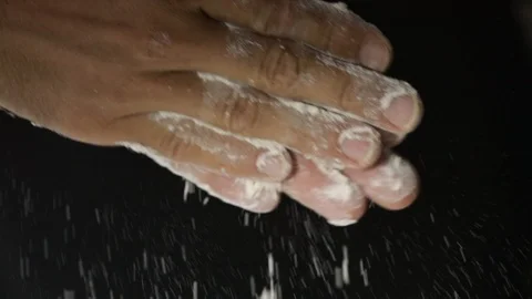 Flour falling from hand in slow motion. Stock Footage 127796896