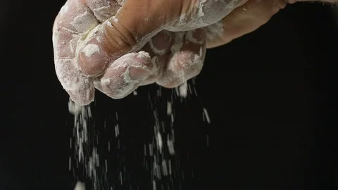 Flour falling from hand in slow motion. Stock Footage 127796903