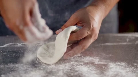 Flour falling from hand at table in slow motion. Close-up of making and prepares Stock Footage 153124446