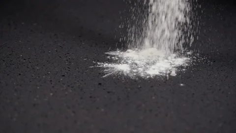 Flour falling onto a kitchen counter in a heap Stock Footage 162482752