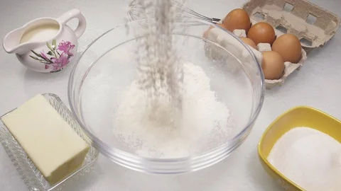Flour falling to make cake slow motion Stock Footage 78110936