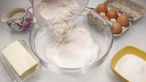 Flour falling to make cake super slow motion Stock Footage 78111272