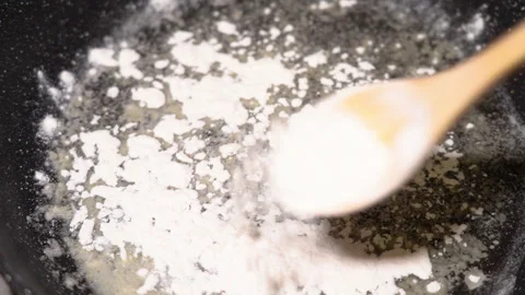 Flour is fried in a pan Stock Footage 249393189
