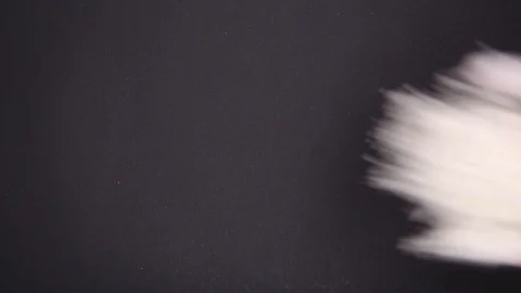 Flour from hands falls on a table on a black background Stock Footage 120412936