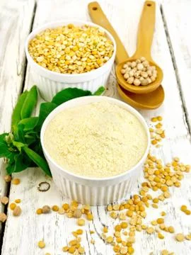Flour pea and split pease in bowls and spoons on light board Stock Photos