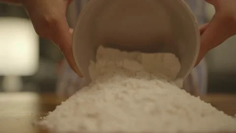 Flour poured from bowl onto work surface Vídeos de archivo 336374581