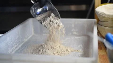Flour is poured into a container for preparing pizza dough Stock Footage 263073101