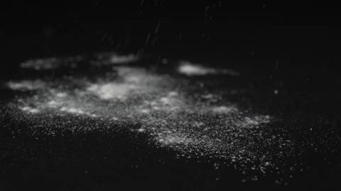 Flour is poured out onto the black surface of the table isolated on black Stock Footage 263743973