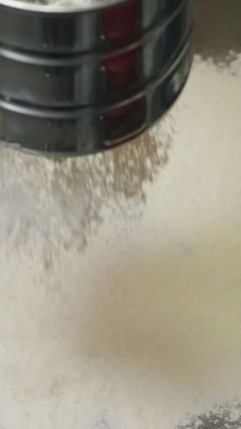Flour is poured out onto the black surface of the table isolated on glass table Stock Footage 301738334