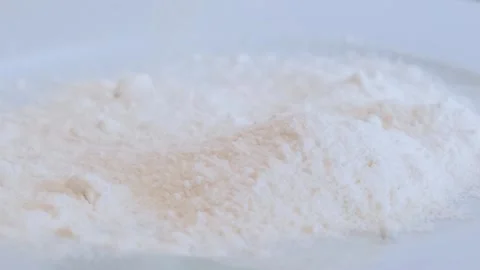Flour is poured onto a plate Stock Footage 285424275