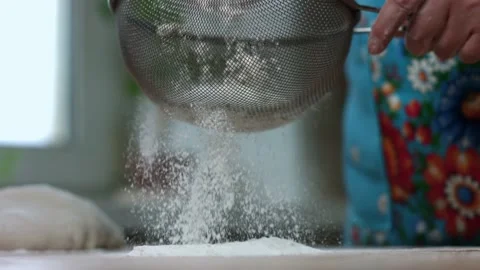 Flour is poured through a sieve Stock Footage 142930107