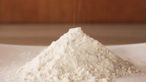 Flour is pouring on table making a heap. Stock Footage 144792785