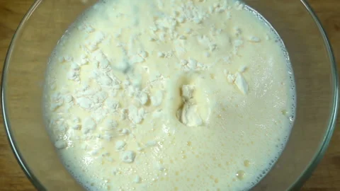 Flour pours into batter in slow motion. Stock Footage 131872145