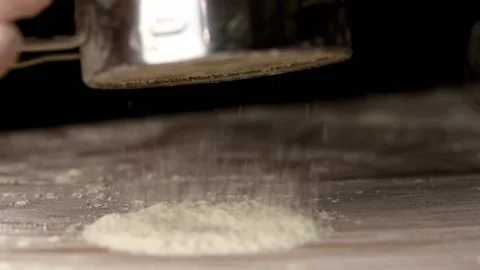 Flour pours out of the sieve on the table, macro Stock-Footage 140258143