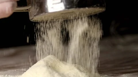 Flour pours out of the sieve on the table, macro Stock Footage 140258201