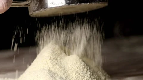 Flour pours out of the sieve on the table, macro Stock-Footage 140258226