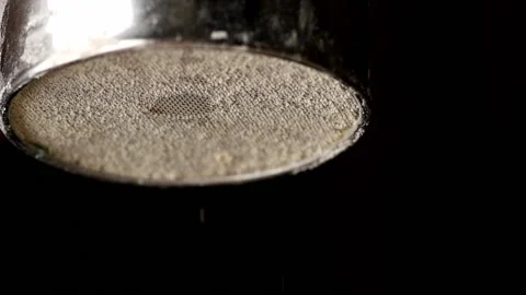 Flour pours from a sieve on a black background, macro Stock Footage 140258366