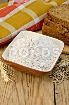 Flour rye in a bowl with bread and ears rye Stock Photos