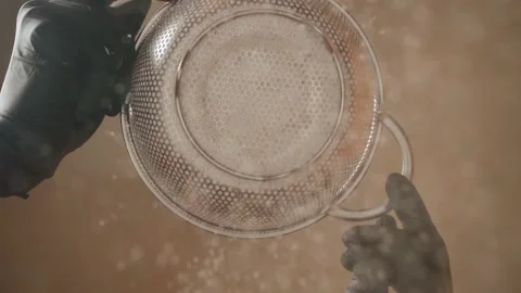 Flour sift through a sieve, kind of bottom. The flour is drunk on camera Stock Footage 152338191