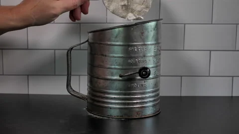 Flour is sifted using vintage sifter in slow motion. Stock Footage 140267760