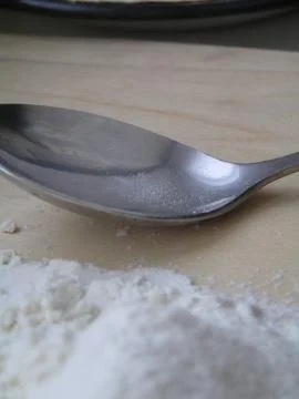 Flour with a spoon Stock Photos
