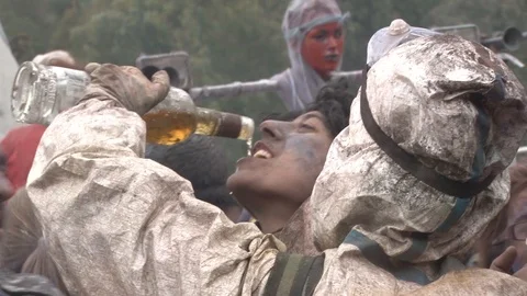 Flour wars people drinking from a bottle, Galaxidi, Greece 스톡 동영상 87616879