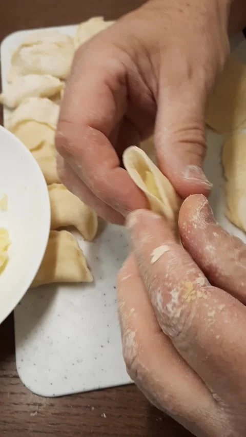 Floured hands making potato dumplings Stock Footage 328451404