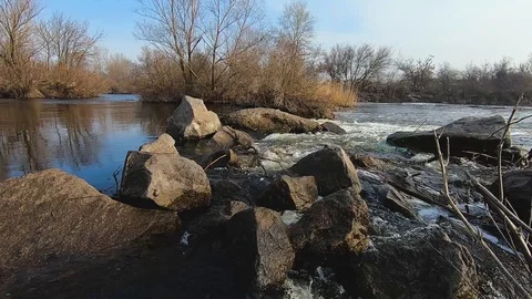 The flow of a clear river among large stones with rapids Video stock 104432662