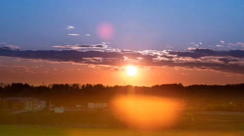 The flow of cloud against the sunset above land. Time lapse Stock-Footage 62738739