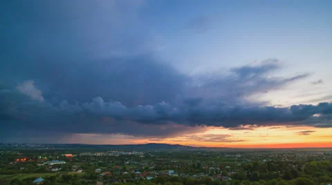 The flow of cloud over the evening city. Time lapse Stock Footage 62922702