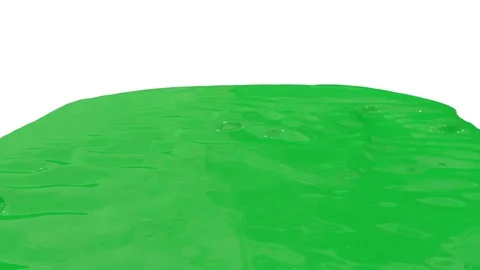 Flow of green paint splattering on white background and dripping down over white Stock Footage 74070948