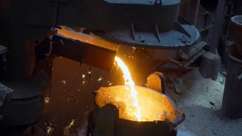 Flow of hot liquid iron cast making sparkles Stock Footage 249620788