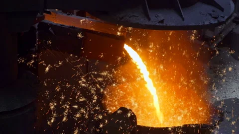 Flow of hot liquid iron making sparkles in a cauldron - metalurgy industry Stock Footage 249620733