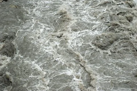 The flow of a mountain rapid river close-up. texture of mountain muddy river, Stock Photos