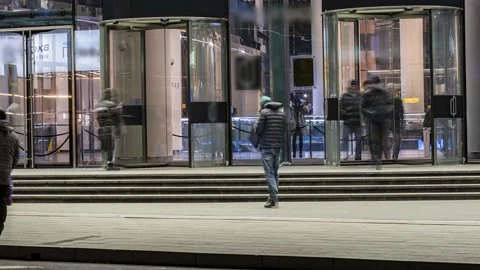 The flow of people passing through the rotating door of the modern office bui Stock Footage 171736295