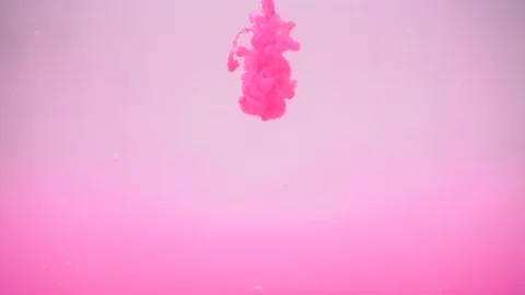 Flow of pink ink cloud burst into water Stock Footage 89448364