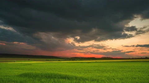 The flow of rain cloud over the city on the background of sunset Video stock 63035678