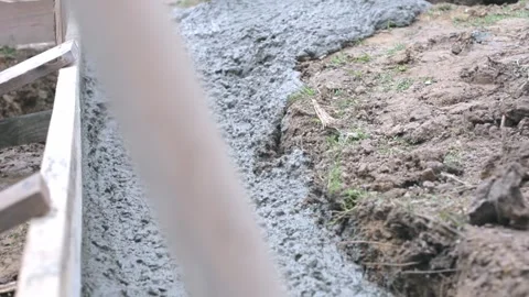 The flow of ready-mixed concrete moves through a specially equipped chute. A Stock Footage 269170640