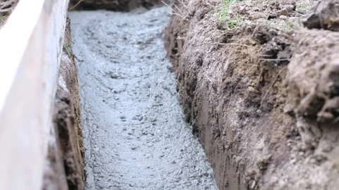 The flow of ready-mixed concrete moves through a specially equipped chute. The Stock Footage 269171252