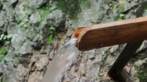 Flow of spring in wooden  gutter in mountains Stock Footage 138380797