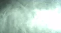 The flow of thick smoke on the dark background. Slow motion capture 4k or 4k+ Resolution