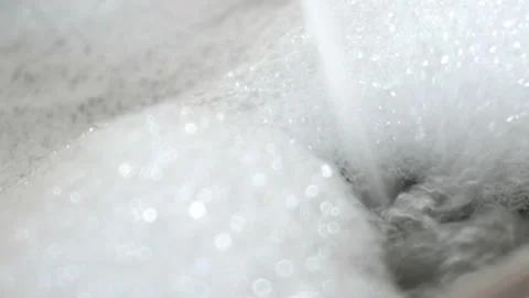 Flow of water into bath with foam. UltraHD video Stock Footage 85625533