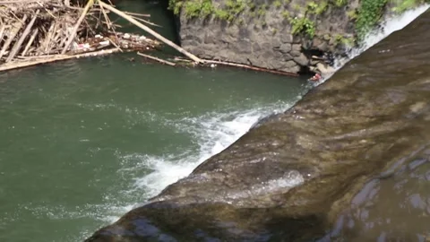 Flow of water on a dam in a clear river. Stock Footage 240596644
