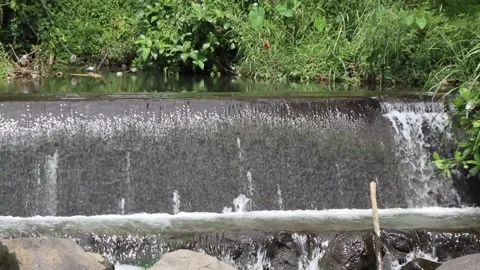Flow of water in a dam. Water flows in river dams Stock Footage 237899643
