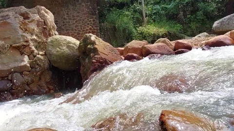 The flow of water flows fast in a clean river Video stock 303390262