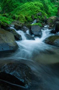 The flow of water hitting the rocks Stock Photos