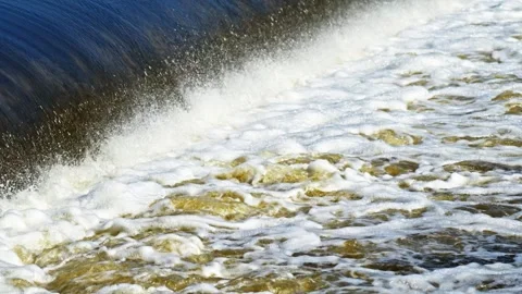 The flow of water from the outlet of an artificial dam Stock Footage 241655645