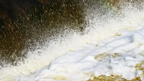 The flow of water from the outlet of an artificial dam Stock Footage 241656667