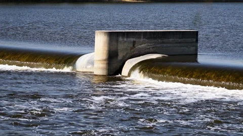 The flow of water from the outlet of an artificial dam Stock Footage 241660033