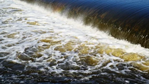 The flow of water from the outlet of an artificial dam Stock Footage 241661016